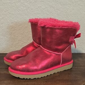 UGG Women's Mini Bailey Bow Glisten boots in Metallic "Radish" pink suede.